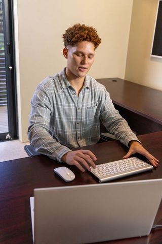 Young Professional Working from Home Office with Laptop