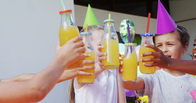 Children Celebrating with Orange Juice in Party Hats - Download Free Stock Images Pikwizard.com