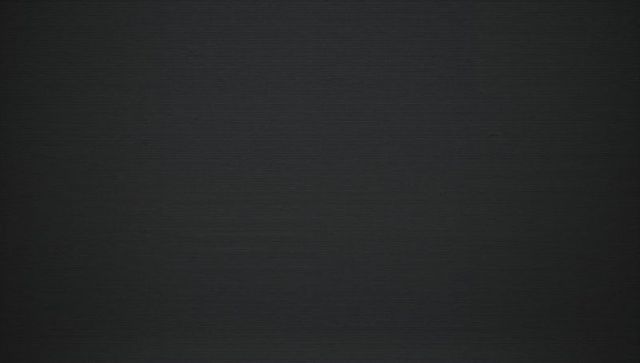 Dark gray horizontal texture with subtle vignette minimal monochrome grain background
