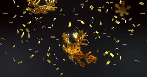 golden confetti falling over christmas decorations in dark ambiance - Download Free Stock Images Pikwizard.com