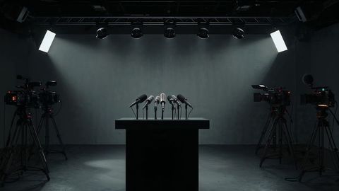 Podium setup with microphones under professional studio lighting