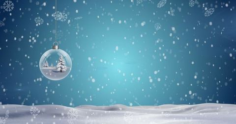Festive Christmas Bauble with Snowy Landscape and Falling Snowflakes