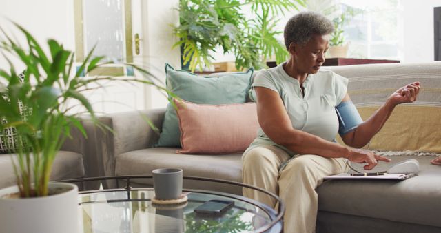 Senior Woman Checking Blood Pressure at Home on Sofa - Download Free Stock Images Pikwizard.com