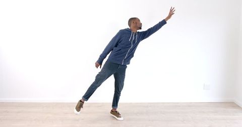 Young Man Stretching Arm Balancing on One Leg Indoors - Download Free Stock Images Pikwizard.com
