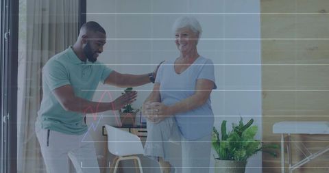 Personal Trainer Assisting Senior Woman with Balance Exercise