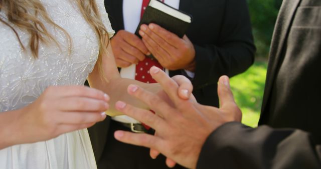 Bride placing ring on groom's finger during wedding ceremony - Download Free Stock Images Pikwizard.com