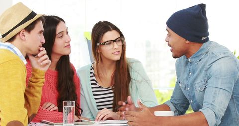 Diverse Young Adults Actively Engaged in Creative Discussion - Download Free Stock Images Pikwizard.com