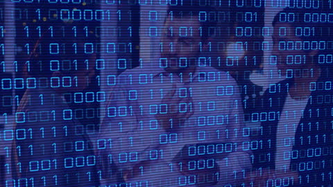 Coworkers Collaborating with Digital Binary Code Overlay