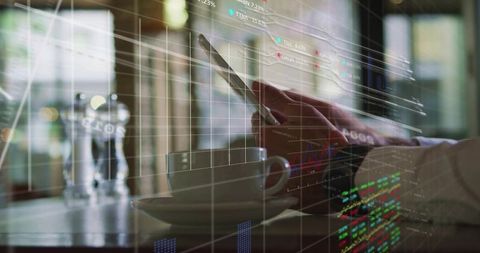 Businessman tapping smartphone in cafe with coffee and stock market data overlay double exposure