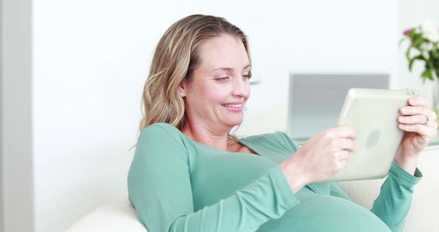 Pregnant Woman Relaxing at Home and Using Digital Tablet - Download Free Stock Images Pikwizard.com