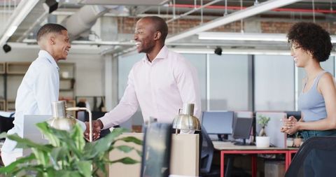 Diverse Colleagues Collaborate in Modern Office on Project