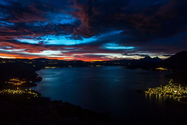 Stunning Twilight Over Mountain Lake with Illuminated Shores - Download Free Stock Photos Pikwizard.com