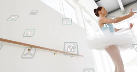 Ballet dancer practicing in studio with digital interface icons