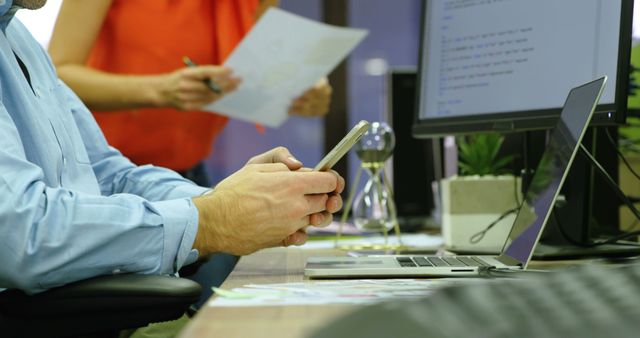 Businessman Using Smartphone in Busy Office Environment - Download Free Stock Images Pikwizard.com