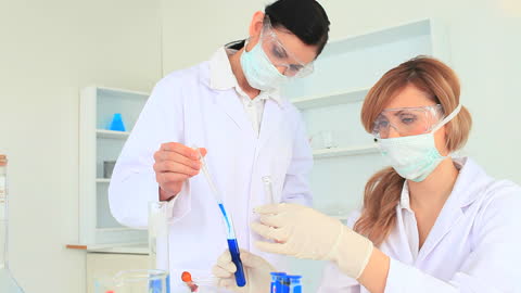 Scientists Conducting Experiment with Test Tubes in Modern Laboratory