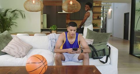 Young athletes relaxing in contemporary living room