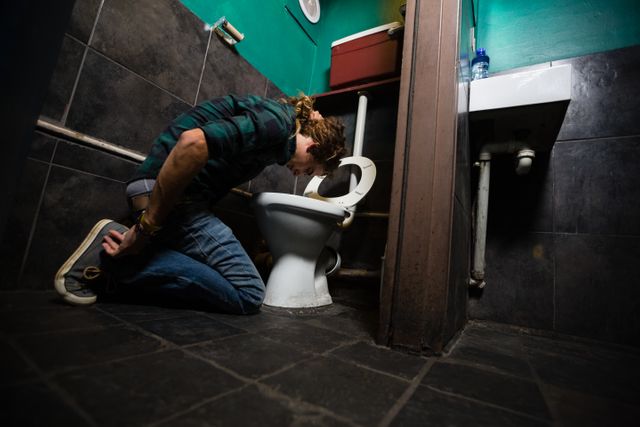 Man vomiting on toilet bowl - Download Free Stock Photos Pikwizard.com