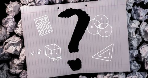 Black question mark with educational symbols on ruled paper