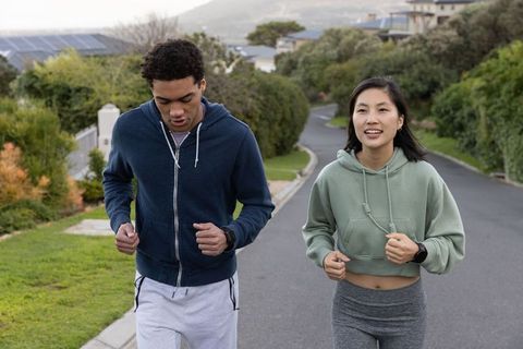 Diverse Runners Exercising Together in Suburban Neighborhood