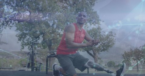 Motivated Athlete with Prosthetic Leg Stretching in Park Environment