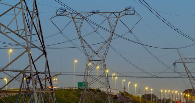 Time lapsed of electricity pylon near highway at dusk. Land vehicles moving on the background 4k