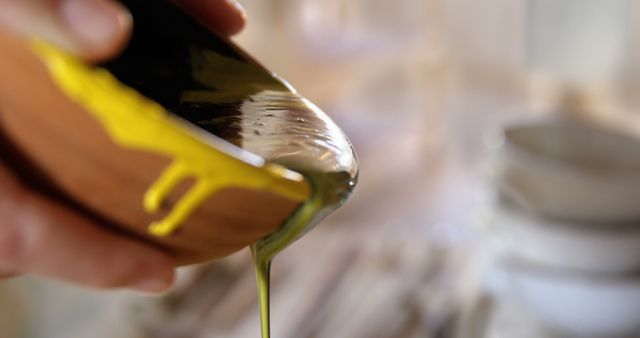 Person Pouring Yellow Paint from Ceramic Bowl - Download Free Stock Images Pikwizard.com