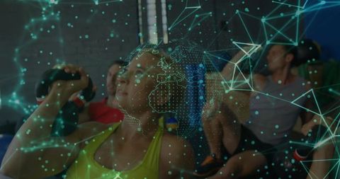 Digital network overlay on woman lifting kettlebell in gym