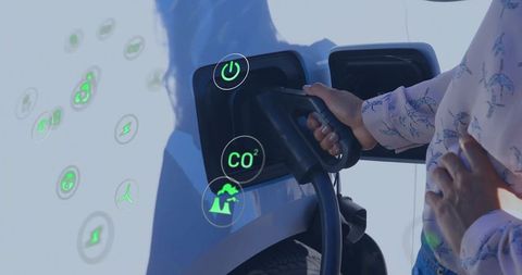 Woman charging electric vehicle with green energy icons