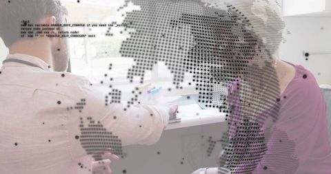 Business mentoring with two professionals reviewing documents and global data overlay