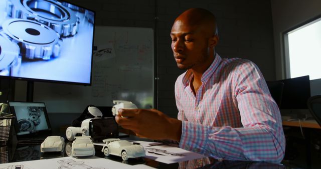 Engineer Working on Model Car Prototypes in Modern Office - Download Free Stock Images Pikwizard.com