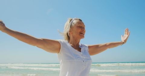 Senior Woman Joyful at Beach Feeling Freedom and Peace - Download Free Stock Images Pikwizard.com