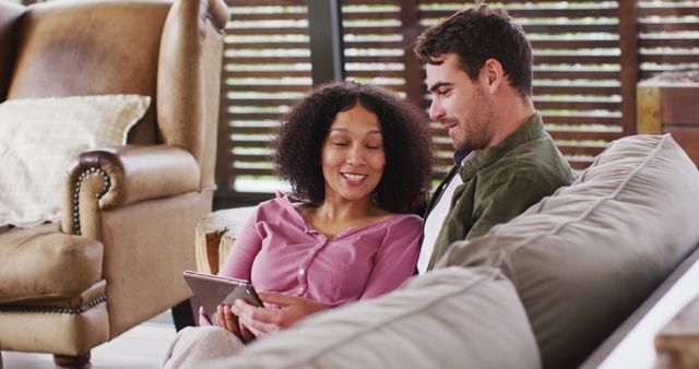 Couple Relaxing on Sofa Watching Tablet Together in Cozy Living Room - Download Free Stock Images Pikwizard.com