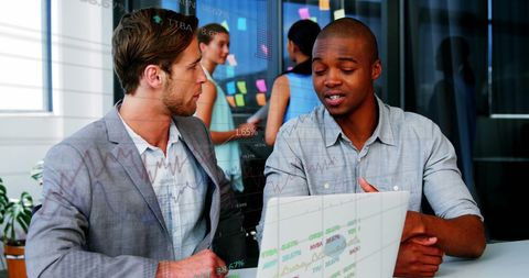 Two Businessmen Analyzing Stock Market Data