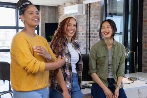 Diverse Team of Women Collaborating in Bright Office Environment
