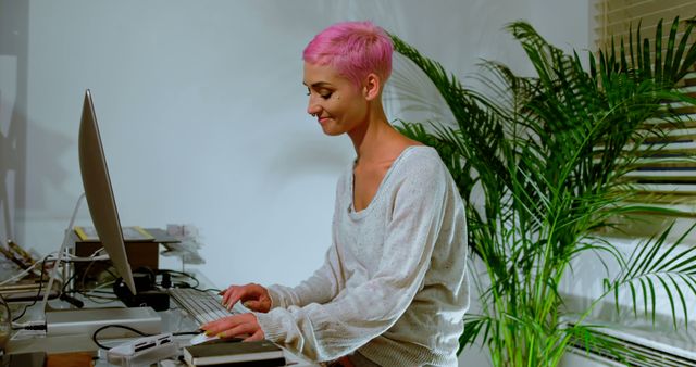 Woman with Pink Hair Working at Office Desk - Download Free Stock Images Pikwizard.com