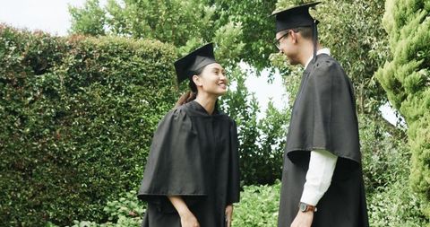Graduating Couple Celebrating Success in Beautiful Garden
