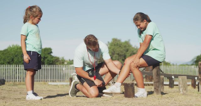 Coach Assisting Youth Sports Injury During Outdoor Practice - Download Free Stock Images Pikwizard.com