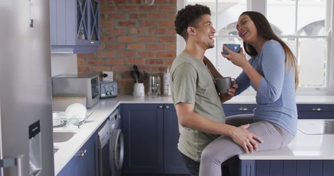 Cheerful Couple Relaxing with Coffee in Modern Kitchen - Download Free Stock Images Pikwizard.com