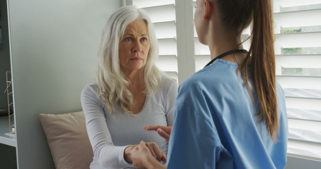 Senior woman consulting with healthcare professional at home - Download Free Stock Images Pikwizard.com