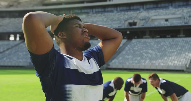 Exhausted Rugby Player Resting During Intense Training Session in Stadium - Download Free Stock Images Pikwizard.com