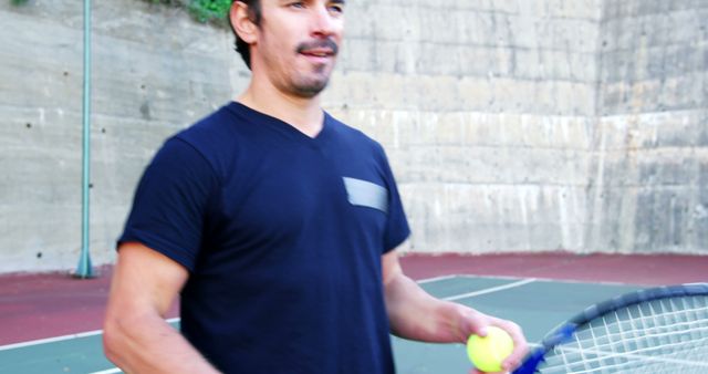 Man Playing Tennis Holding Racket and Ball Outdoors - Download Free Stock Images Pikwizard.com