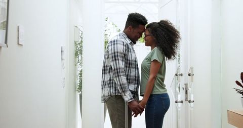 Happy Couple Embracing at Home Entrance