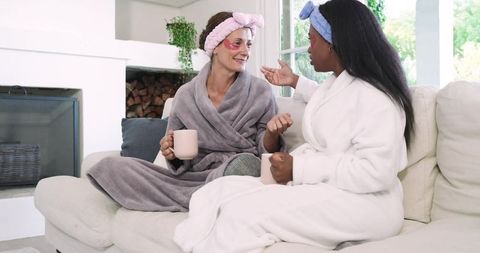 Diverse female friends enjoying relaxing spa day at home