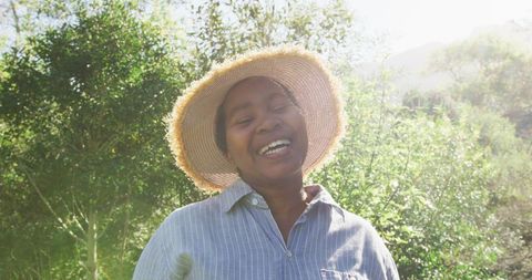 Happy Senior Woman Gardening in Sunlit Garden