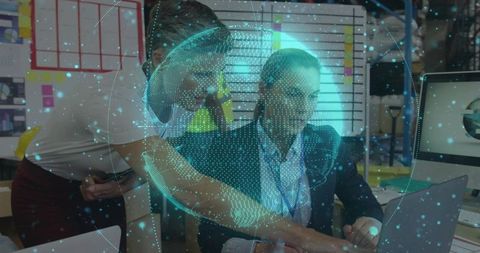 Collaborating team reviewing AR globe on laptop in futuristic augmented reality workspace