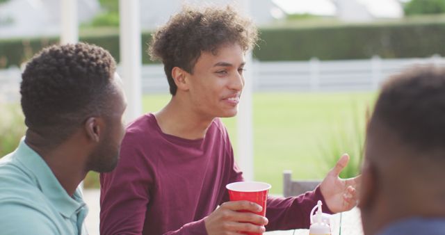 Young Friends Socializing Outdoors with Red Plastic Cups - Download Free Stock Images Pikwizard.com