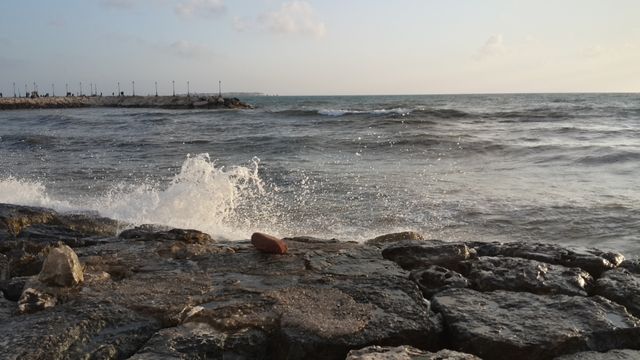 Rocky Shoreline with Splashing Waves at Sunset - Download Free Stock Photos Pikwizard.com