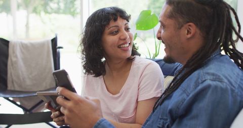 Biracial Couple Enjoying Time with Technology at Home