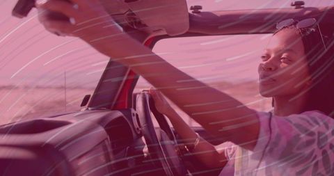 Woman Driving Red Convertible on Open Desert Road