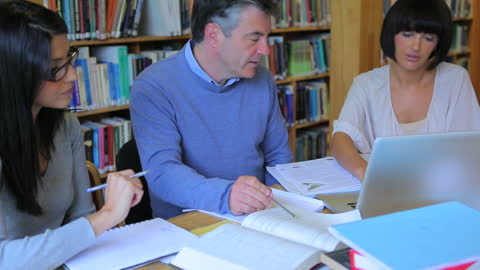 Mature Students Collaborating in College Library